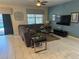 Inviting living room featuring a comfortable sectional sofa and neutral tile floors, ideal for relaxation and entertaining at 9158 Scramble Dr, Davenport, FL 33896