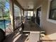 Inviting outdoor covered patio, designed for alfresco dining and entertaining, offers a seamless extension to the pool area at 9158 Scramble Dr, Davenport, FL 33896