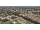 Wide aerial shot showcases the property among a neighborhood with mature trees and community features at 927 Mare Bello Dr, Winter Park, FL 32792