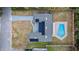 Aerial view showcasing the home's layout, solar panels, a private pool, and fenced yard at 927 Mare Bello Dr, Winter Park, FL 32792