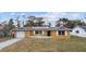 Charming single-story home with a well-manicured lawn, solar panels and a one car garage at 927 Mare Bello Dr, Winter Park, FL 32792