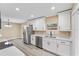 Modern kitchen features stainless steel appliances, white cabinets, and ample counter space at 927 Mare Bello Dr, Winter Park, FL 32792