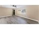 Bright and open living room with modern flooring and natural light from a large window at 927 Mare Bello Dr, Winter Park, FL 32792