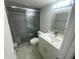 Updated bathroom featuring a modern vanity, and tiled shower with glass door and built-in seat at 1014 Plantation Dr # A9, Kissimmee, FL 34741