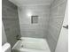 Bathroom featuring a tub with tiled walls, offering a clean and updated look and feel at 1014 Plantation Dr # A9, Kissimmee, FL 34741