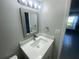 Bathroom featuring a modern vanity and mirror in a well-lit space near the bedroom at 1014 Plantation Dr # A9, Kissimmee, FL 34741