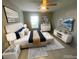 Modern bedroom with decorative art, neutral walls, and a queen bed with luxurious linens at 1014 Plantation Dr # A9, Kissimmee, FL 34741