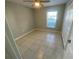 Neutral bedroom with tiled floor and window to let in natural light and large closet for storage at 1014 Plantation Dr # A9, Kissimmee, FL 34741