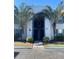Two-story condo building with palm trees and a central staircase at 1014 Plantation Dr # A9, Kissimmee, FL 34741
