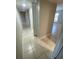 Hallway showcasing neutral colors, tile flooring, closet space, and an inviting layout for a comfortable home at 1014 Plantation Dr # A9, Kissimmee, FL 34741