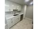 Bright kitchen featuring white cabinetry, stainless steel sink, and modern appliances at 1014 Plantation Dr # A9, Kissimmee, FL 34741