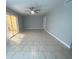 Spacious living area with tile flooring, a modern ceiling fan, and access to an outdoor lanai through sliding glass doors at 1014 Plantation Dr # A9, Kissimmee, FL 34741
