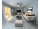 Cozy living room featuring a modern ceiling fan, stylish decor, and sliding glass doors to the lanai at 1014 Plantation Dr # A9, Kissimmee, FL 34741