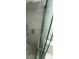 Modern shower with gray tiles, a rainfall showerhead, handheld sprayer, and glass door at 1014 Plantation Dr # A9, Kissimmee, FL 34741