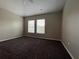 Well-lit bedroom with neutral walls and carpet at 10238 Cala Lily Trl # S, Orlando, FL 32832