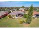 Drone shot of home's backyard featuring a screened lanai and lush lawn at 127 Terra Vista Ln, Kissimmee, FL 34759