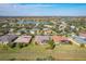 Aerial view of homes in a lakeside community featuring mature trees and well-maintained yards at 127 Terra Vista Ln, Kissimmee, FL 34759