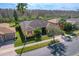 Charming yellow home featuring a well-manicured lawn, mature landscaping, and a paved driveway on a sunny day at 127 Terra Vista Ln, Kissimmee, FL 34759
