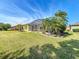 Well-maintained backyard with a screened lanai and tropical landscaping at 127 Terra Vista Ln, Kissimmee, FL 34759
