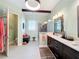 Bright bathroom features a walk-in shower, dual vanity, and modern lighting at 127 Terra Vista Ln, Kissimmee, FL 34759
