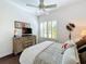 Cozy bedroom with ceiling fan, wood dresser, and bright windows with plantation shutters at 127 Terra Vista Ln, Kissimmee, FL 34759