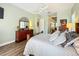 Comfortable bedroom with a ceiling fan, wood floors, and ample storage at 127 Terra Vista Ln, Kissimmee, FL 34759