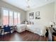 Bright bedroom with twin beds, work station, and a large window with plantation shutters at 127 Terra Vista Ln, Kissimmee, FL 34759