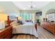A bedroom with wood flooring, a ceiling fan, and doors to the outside at 127 Terra Vista Ln, Kissimmee, FL 34759