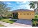 Single story home featuring manicured lawn and mature landscaping including palm trees and front porch at 127 Terra Vista Ln, Kissimmee, FL 34759
