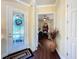 Inviting foyer with a decorative glass front door and wood flooring leading to the rest of the home at 127 Terra Vista Ln, Kissimmee, FL 34759