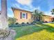 Charming single-story home featuring a well-manicured lawn and beautiful landscaping at 127 Terra Vista Ln, Kissimmee, FL 34759