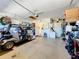 Spacious garage with epoxy floors, an electric golf cart, and lots of organized storage at 127 Terra Vista Ln, Kissimmee, FL 34759