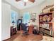 Cozy home office features wood flooring, a ceiling fan, plantation shutters, and custom shelving, creating a workspace at 127 Terra Vista Ln, Kissimmee, FL 34759