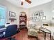 Inviting home office featuring wood floors, a ceiling fan, a work space and natural light from the window shutters at 127 Terra Vista Ln, Kissimmee, FL 34759