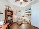 This home office offers wood flooring, a ceiling fan, decor, and natural light, creating an inviting and productive atmosphere at 127 Terra Vista Ln, Kissimmee, FL 34759