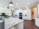 Modern kitchen featuring granite counters, stainless appliances and white cabinets at 127 Terra Vista Ln, Kissimmee, FL 34759