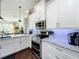 Open kitchen featuring stainless appliances, white cabinetry, granite countertops, and bar seating at 127 Terra Vista Ln, Kissimmee, FL 34759