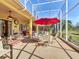 Spacious screened lanai with a dining set, lounge furniture, and a ceiling fan at 127 Terra Vista Ln, Kissimmee, FL 34759