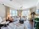 Bright living room featuring neutral tones, large windows, and comfortable seating at 127 Terra Vista Ln, Kissimmee, FL 34759