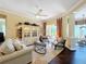 Comfortable living room featuring a light color sofa, an area rug, a large decorative cabinet and outdoor patio access at 127 Terra Vista Ln, Kissimmee, FL 34759