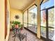 Inviting screened front porch with seating, decor, and views of the well-maintained front yard and exterior at 127 Terra Vista Ln, Kissimmee, FL 34759