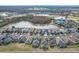 Aerial view of the neighborhood, featuring a lake, golf course, and neatly arranged homes at 1404 Lexington Avenue, Davenport, FL 33837