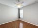 Comfortable bedroom with wood floors, ceiling fan and window coverings at 1404 Lexington Avenue, Davenport, FL 33837