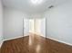 Well-lit bedroom with wood floors and access to other rooms at 1404 Lexington Avenue, Davenport, FL 33837