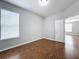 A spacious bedroom with hardwood floors, natural lighting, and a doorway at 1404 Lexington Avenue, Davenport, FL 33837