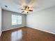 This bedroom boasts hardwood floors and a ceiling fan at 1404 Lexington Avenue, Davenport, FL 33837