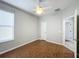 Bedroom with ceiling fan, wood flooring, and access to bathroom at 1404 Lexington Avenue, Davenport, FL 33837