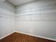 Walk-in closet with wooden floors and installed shelving at 1404 Lexington Avenue, Davenport, FL 33837