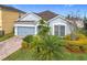 Charming single-Gathering home boasts a well-manicured lawn and an attached two-car garage at 1404 Lexington Avenue, Davenport, FL 33837