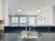 Kitchen features a large double sink with a modern faucet at 1404 Lexington Avenue, Davenport, FL 33837